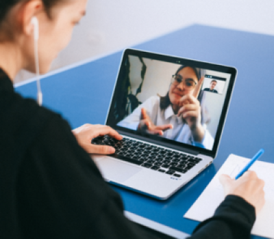 Patient attending a virtual psychiatric telehealth appointment on a laptop